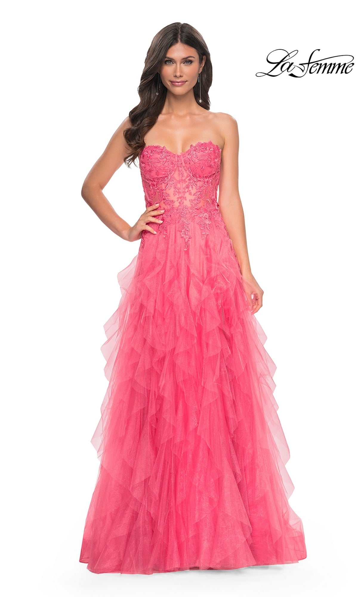 A woman models the La Femme Strapless Long Coral Prom Dress 32286, featuring a beaded-lace bodice and layered tulle A-line skirt, radiating elegance against a white background.